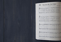 pages of an open hymnal - Jesus Loves me this I know 