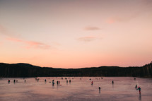 ice skating on a frozen lake at sunset 