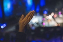 hands raised in praise at a concert 