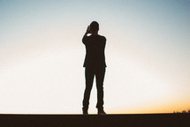 silhouette of a man holding a camera 