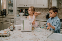kids baking cookies in a kitchen


