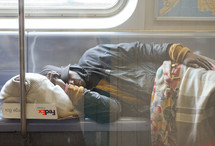 a man sleeping on a train 