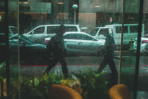 pedestrians walking in the rain 