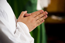 praying hands of a priest 