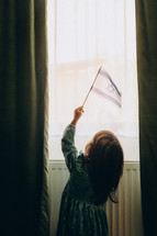 Innocence and Hope: A 4-Year-Old Girl Waving the Israeli Flag