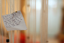 a prayer for family pinned to a curtain 