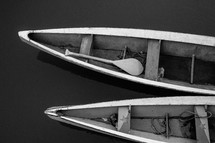 oar in a boat floating on water 