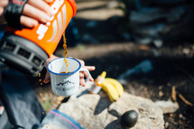 pouring coffee while camping 