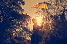 woman holding up an umbrella to block the sunlight 