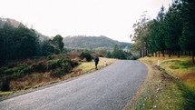 man walking along a country road 