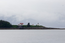 house and lighthouse on a coast
