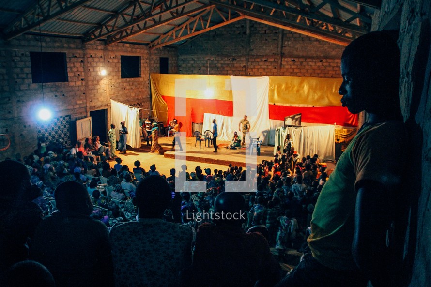 audience watching a drama performance on stage 