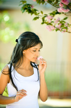 woman smelling a flower 