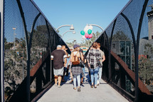 people walking across a bridge 