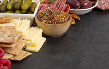 Mustard on charcuterie board with snacking food