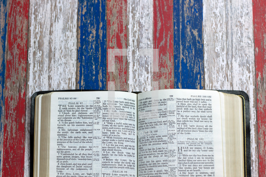 open Bible on weathered red, white, and blue 