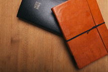 leather journal and Bible on a table 