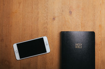 iphone and Bible on a table 