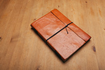 leather journal on a table 