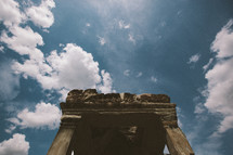 columns in ruins and clouds in a blue sky