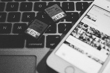 SD cards on a computer keyboard and iPhone 