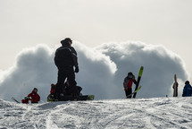 skiers at the top of a slope 