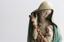 statue of Mary and baby Jesus with a rosary 