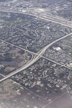 Aerial view of an interstate and surrounding town.