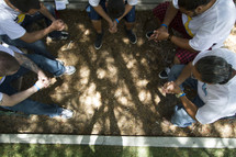 Group in circle praying