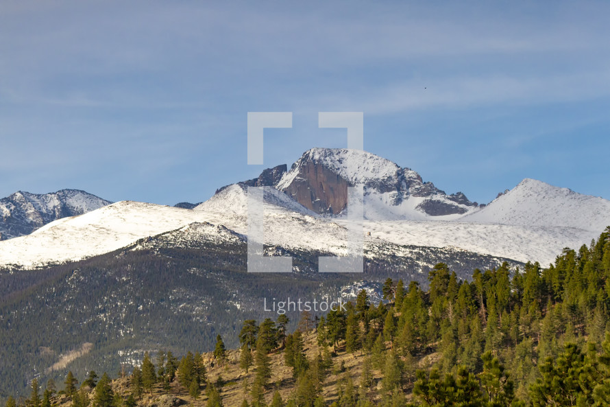 snow capped mountains and evergreen forest 