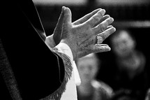 priest with praying hands 