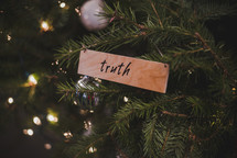 truth wooden ornament on a Christmas tree 
