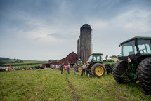 people and tractors on a farm 