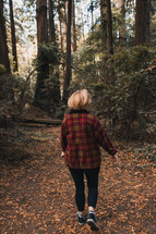 woman walking through a forest in fall 