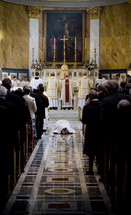Priest prostrating during mass.