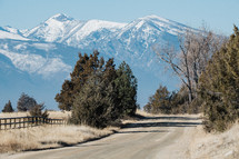 dirt road and snow capped mountain peaks 