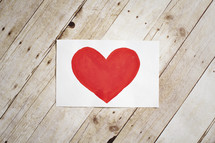 painting of a red heart on paper 