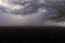 parachuting under a cloudy sky 