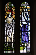 Stained Glass Window proclaiming 'He is Risen'.