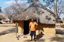 a man standing in an African village 