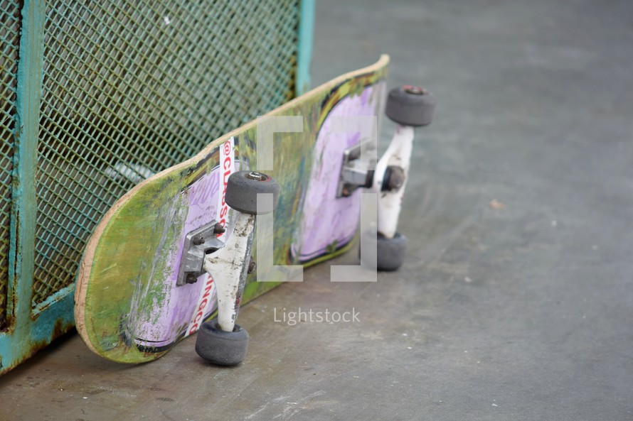 skateboard leaning against a wall on a pier in Huntington Beach, California 