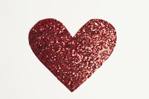 A red glittery paper heart cut-out 