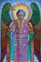 Tile mosaic of an angel holding scales 