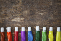 row of a rainbow of paints 