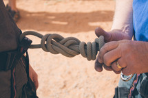 tying a knot for scaling rocks, rock climbing