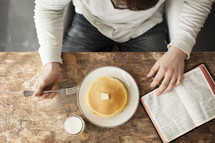 Reading the Bible over breakfast.