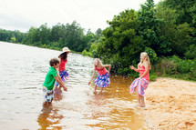 children playing in lake water 