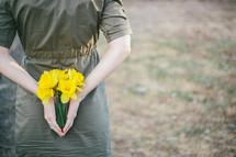 Daffodils behind her back.