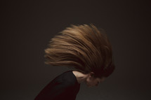 A woman tossing her hair 