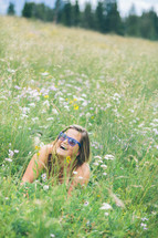 woman lying in a field of wildflowers 